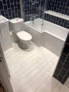 White bathroom floor tiles installed by a tiler in Portsmouth