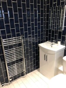 Black wall tiles installed in a bathroom in Portsmouth