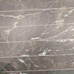 Patterned natural stone tiling floor with distinctive white veining.
