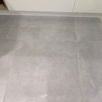 Tiled floor with a gray stone texture, designed for bathroom tiling.